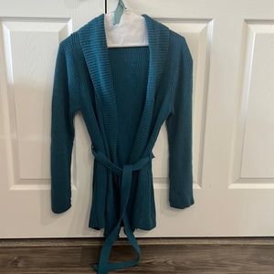 Knit, long sleeve cardigan sweater with strap to toe around waist